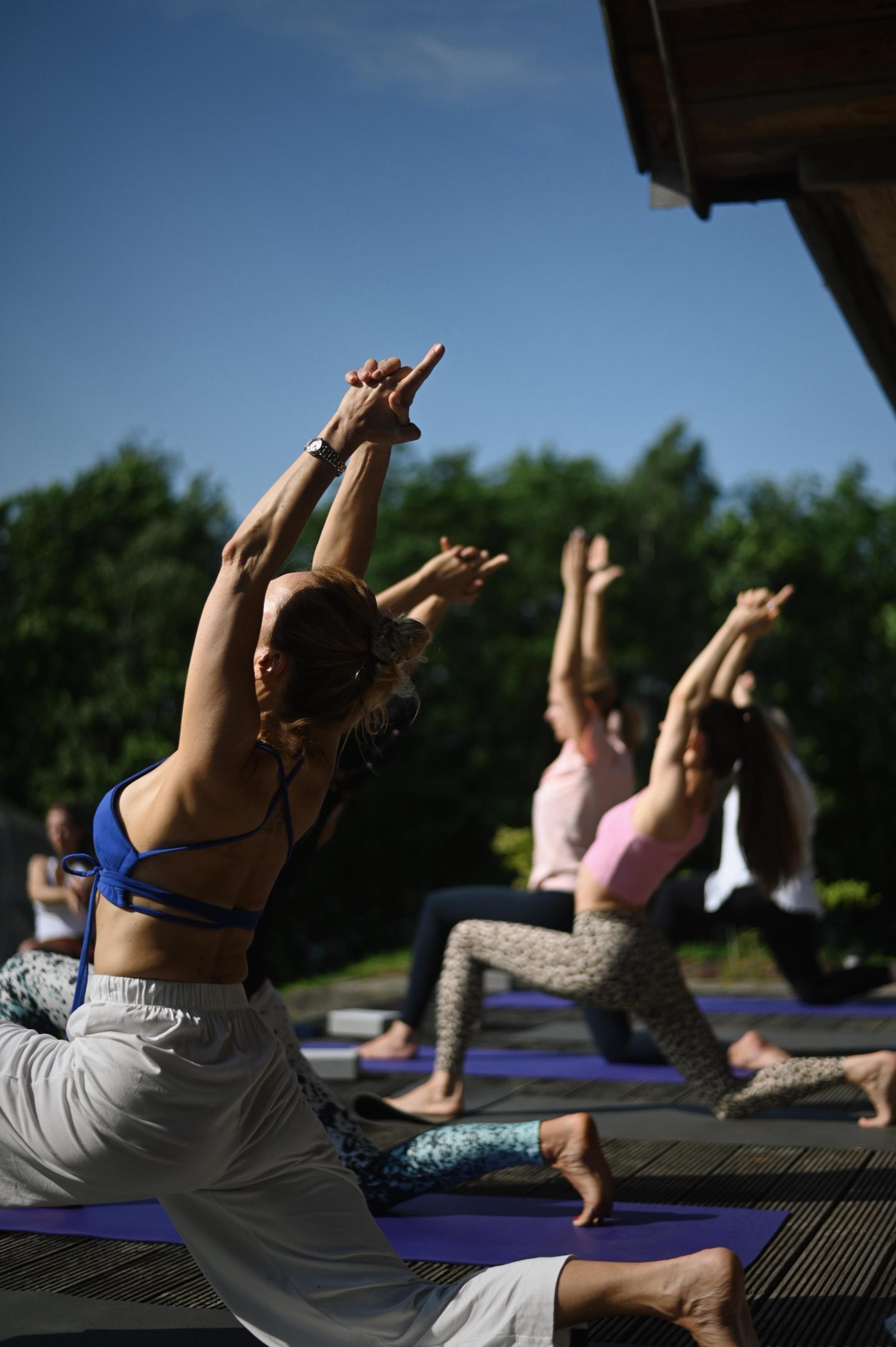 Morning yoga practice outdoors — arms raised on an inhale
